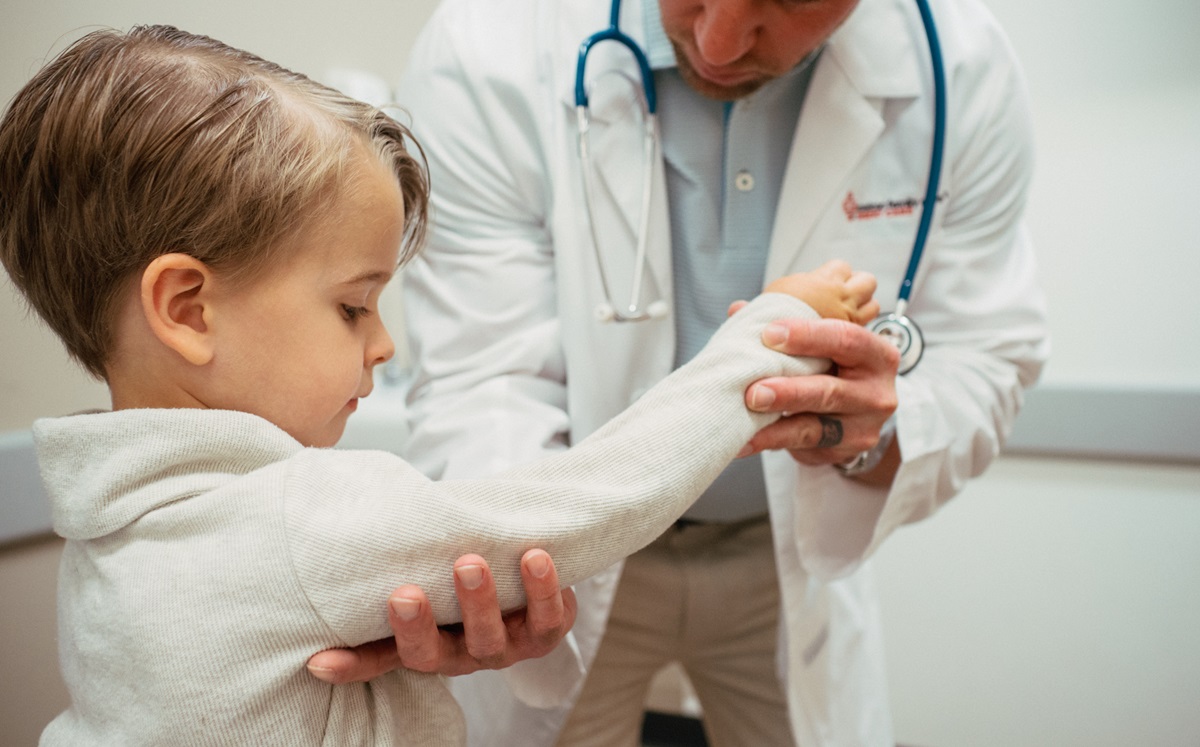 Provider examining child's elbow